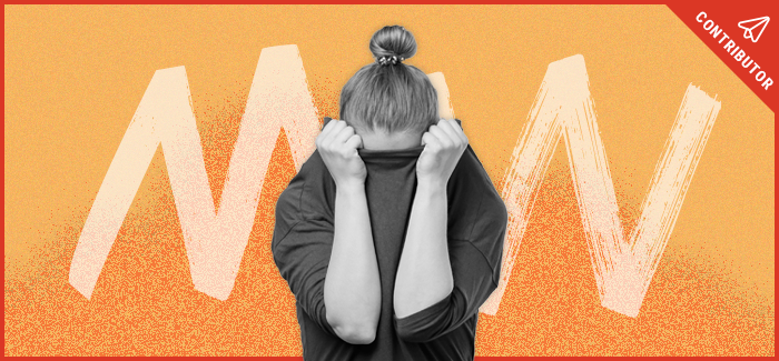 Woman hiding her face into her shirt after facing invisible disabilities stigma.