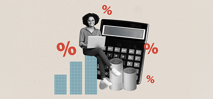 A female professional sitting next to a calculator to represent saving on a University of Phoenix degree