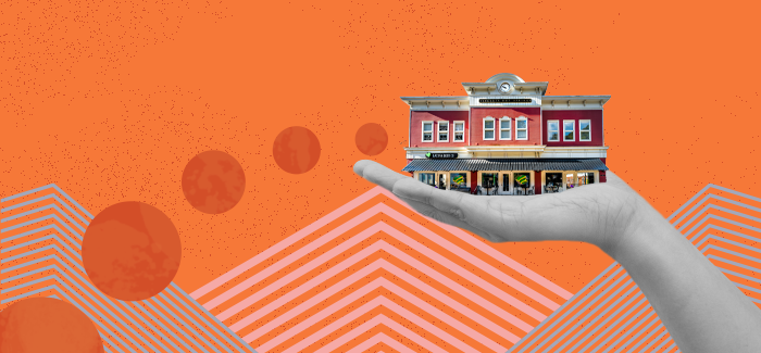 Hand holding a building to signify tips for successfully starting a business