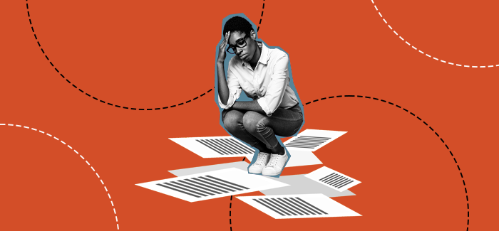 A person looking stressed over resumes to represent why is it so hard to find a job