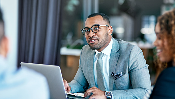 Advisor on laptop in a meeting