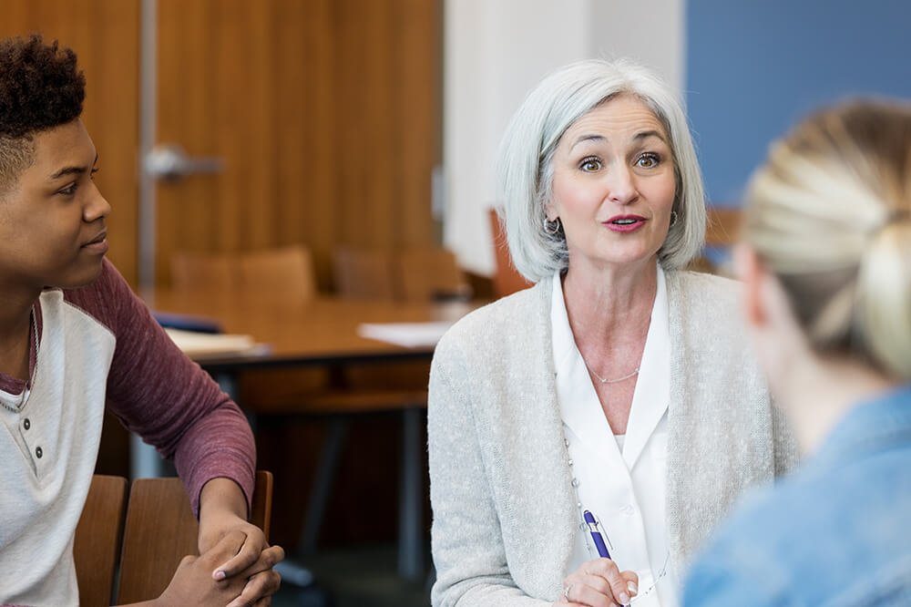 A principal meets with teachers