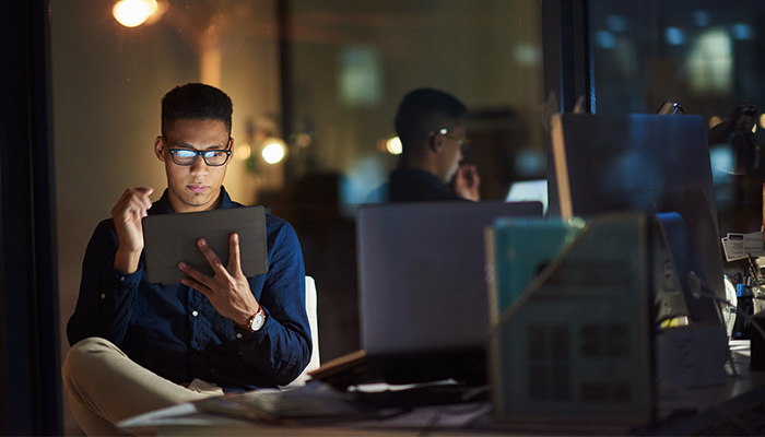 Software developer working on a tablet in an office space