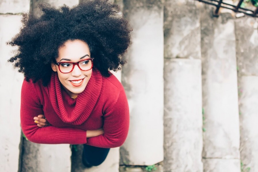 Woman with glasses walking up stairs