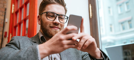 A business person reading their phone.