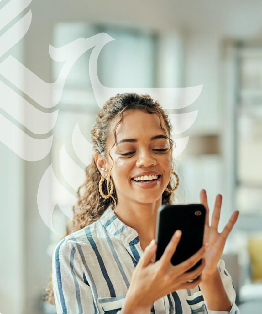 A smiling businessperson answers her mobile phone to talk with an enrollment representative.