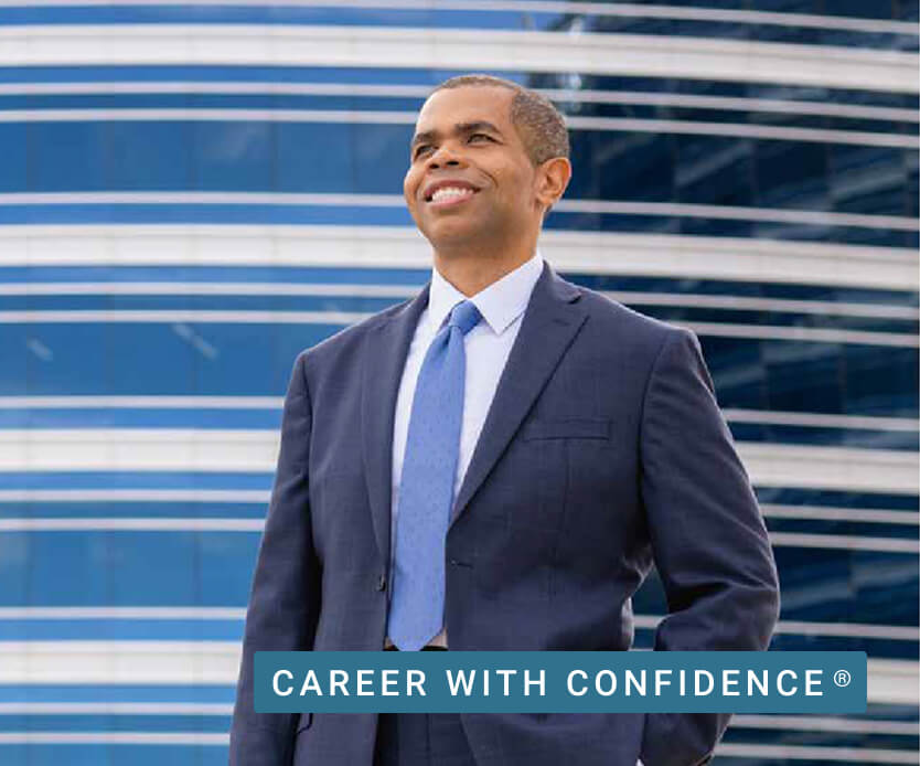 A smiling University of Phoenix graduate faces his future confidently.