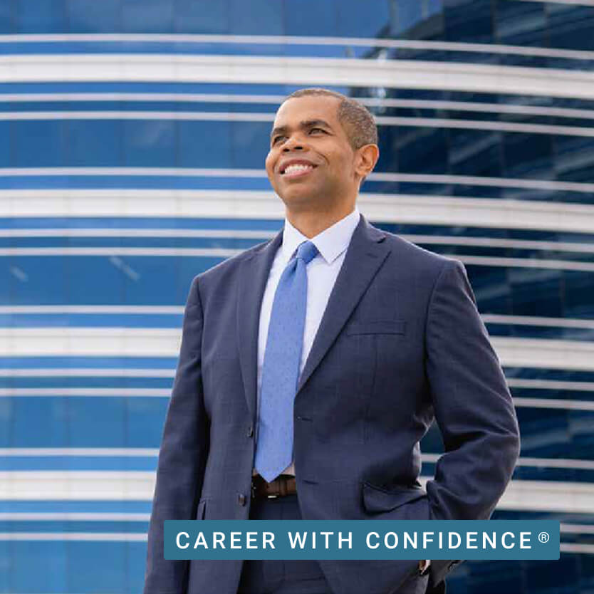 A smiling University of Phoenix graduate faces his future confidently.