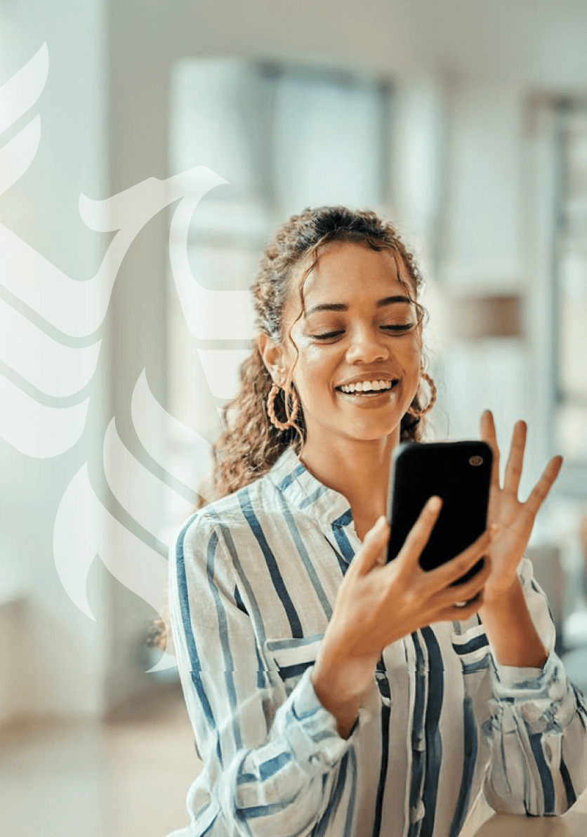A smiling businessperson answers her mobile phone to talk with an enrollment representative.
