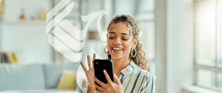A smiling businessperson answers her mobile phone to talk with an enrollment representative.