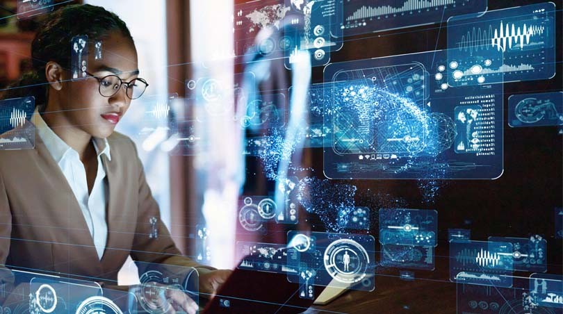 A woman working on a computer with images of cybersecurity analysis