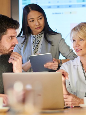 Woman working confidently on a project with her colleagues