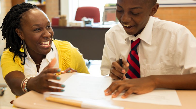 A teacher helping a student with their work