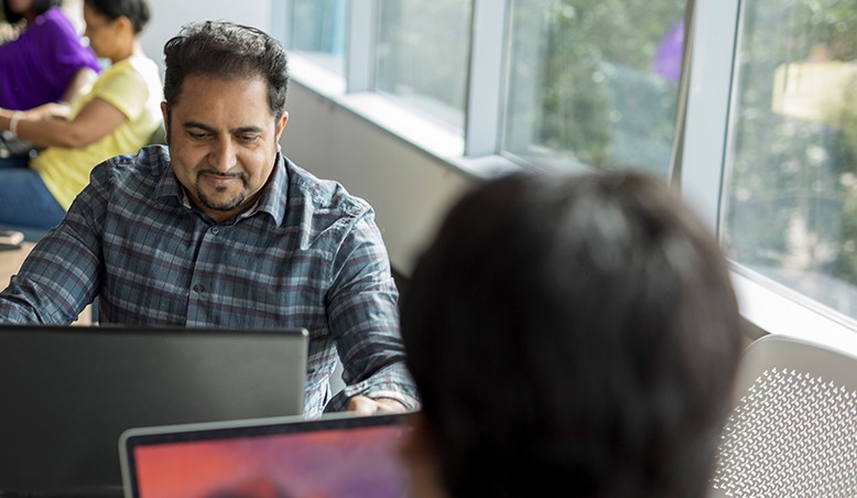 A student looks up Master of Information Systems degrees at University of Phoenix