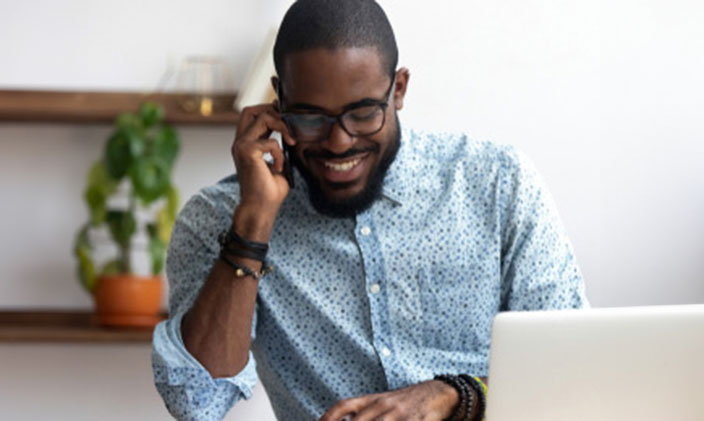 Enrollment counselor working on laptop