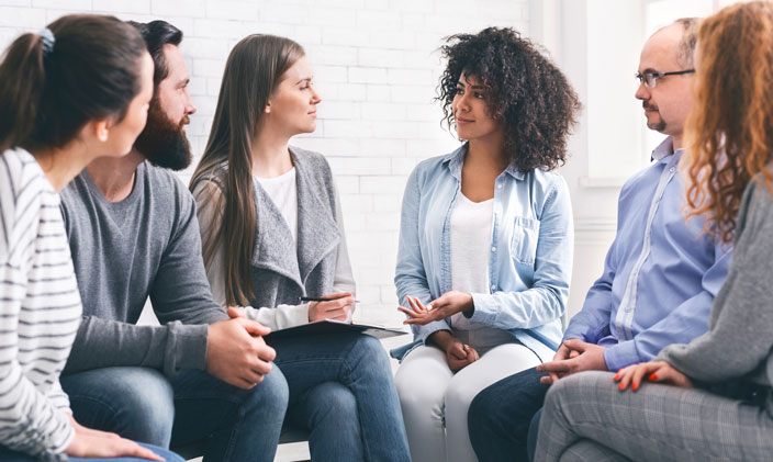 Small group of people gathered in deep conversation