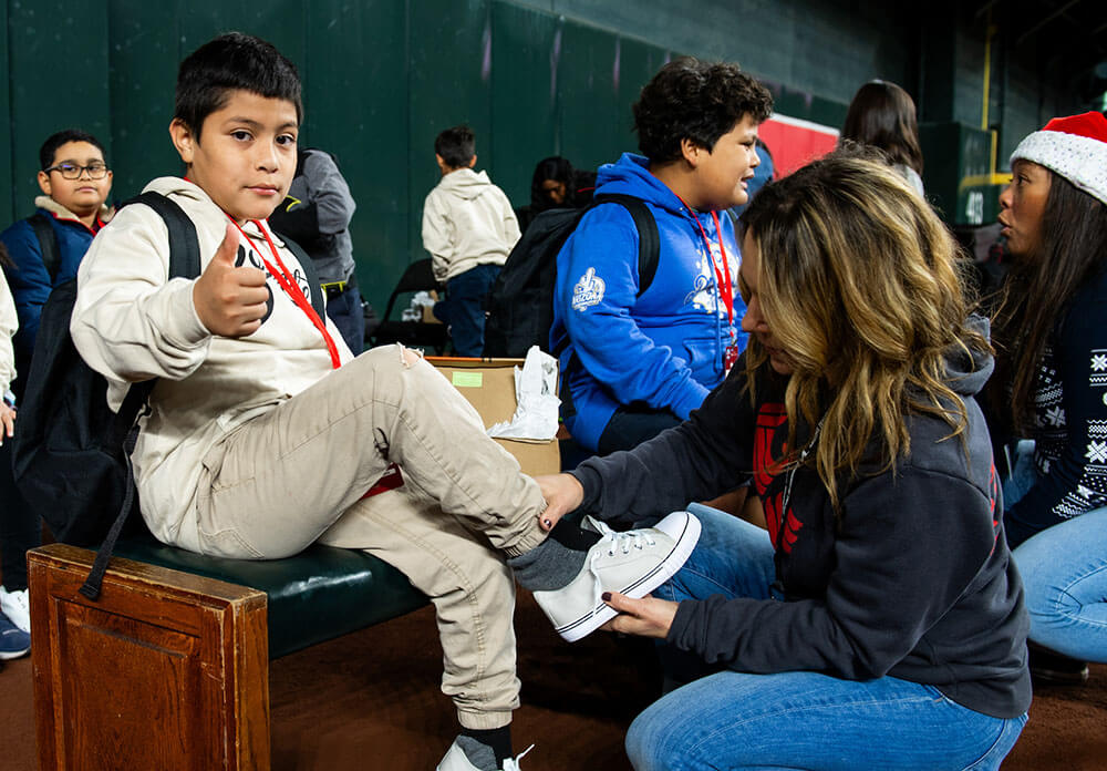 Employees assisting underserved children in the community