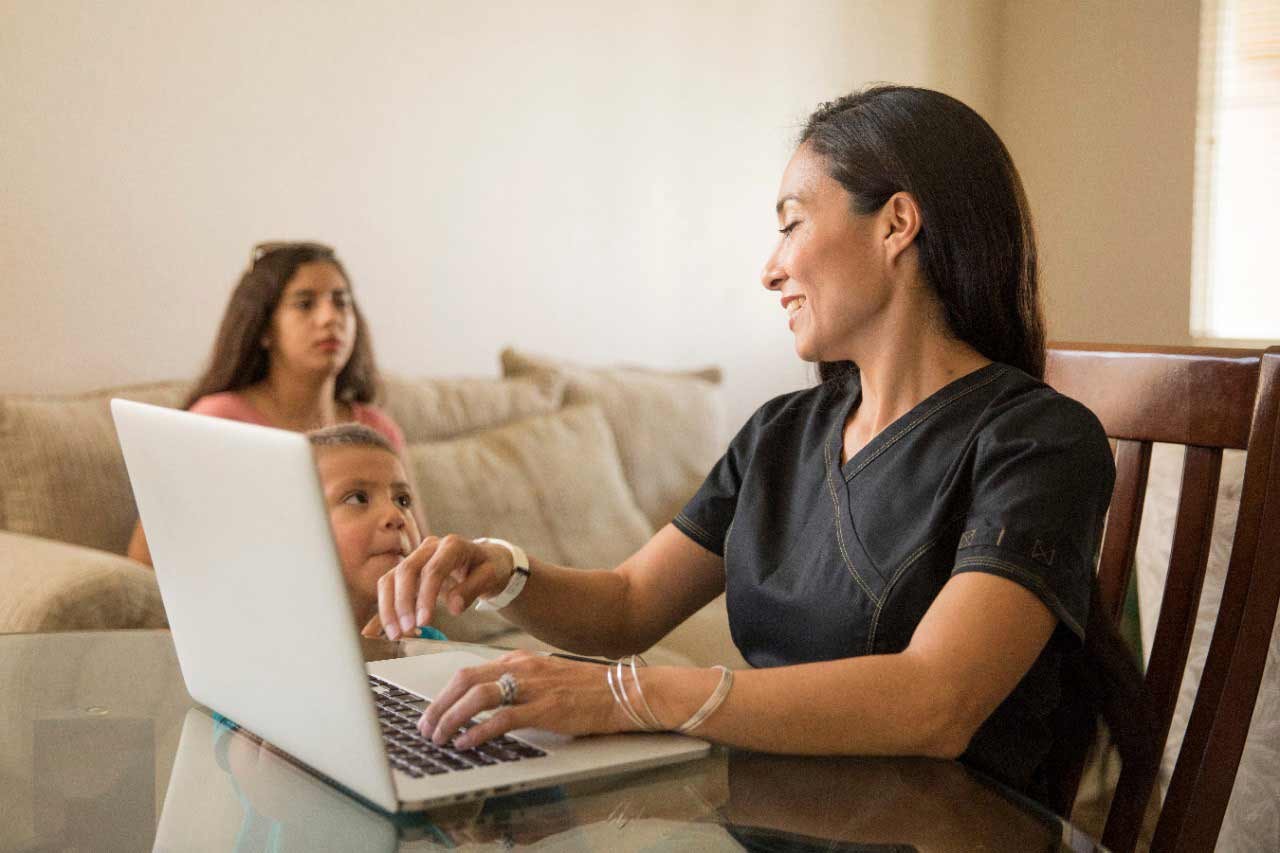 Student working from home with children