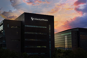 Link to an image of the University of Phoenix building silhouetted against a pink and purple sky