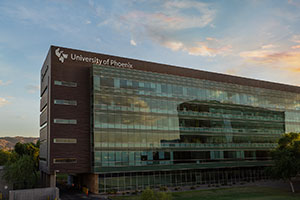 Link to an image of the University of Phoenix building situated in the lower right portion of the frame under a dusky sky