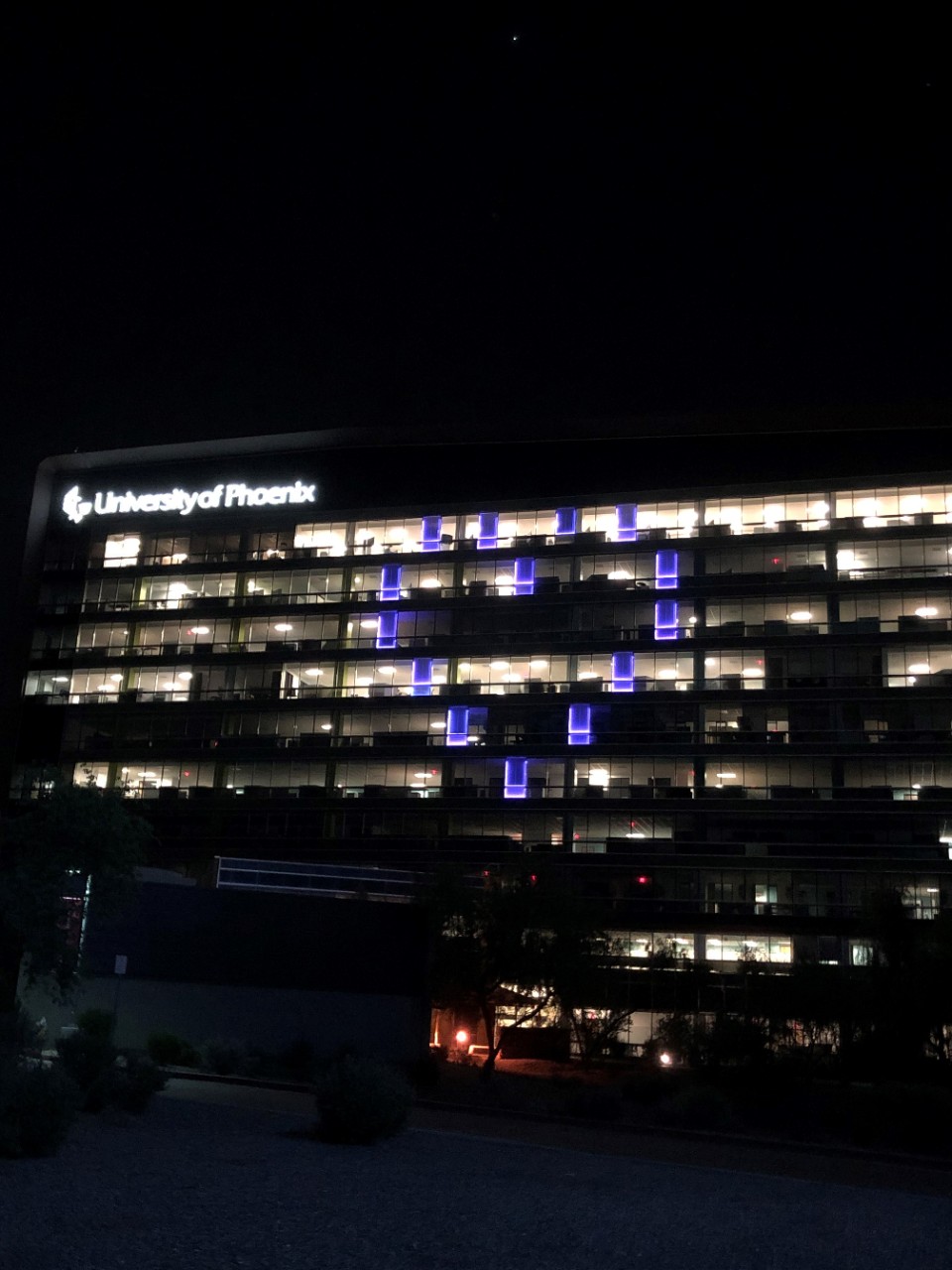 University of Phoenix building lit with a blue heart