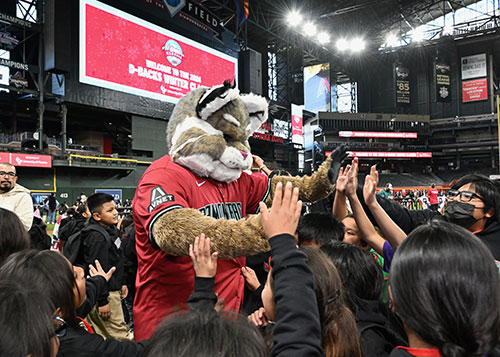 School children high fiving the Arizona Diamondback's mascot at the Winter Classic celebration.