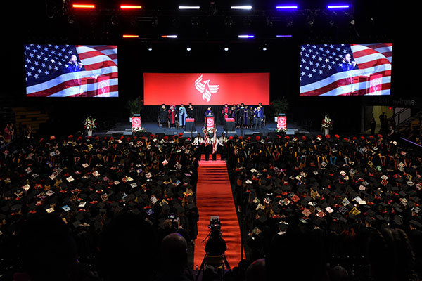 Graduates fill the Addition Financial Arena for University of Phoenix's commencement ceremony.