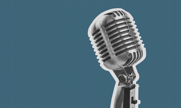 A silver microphone on the right hand of the frame against a dark teal background.
