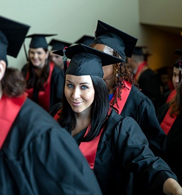 Military student in regalia prepares to graduate with bachelor’s degree at University of Phoenix ceremony