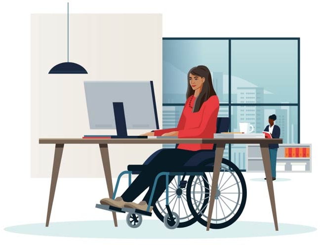 A woman in a wheelchair focused on her work at a computer, demonstrating determination.