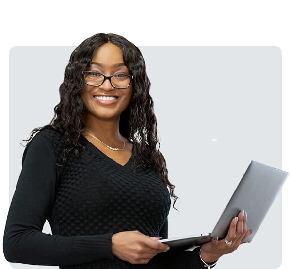 Student holds a laptop and prepares to explore dissertation support tools for the online DBA program.