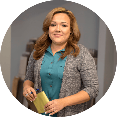 Business student smiling and holding a piece of paper