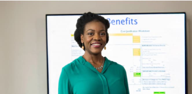 Business student presenting from a board in a classroom