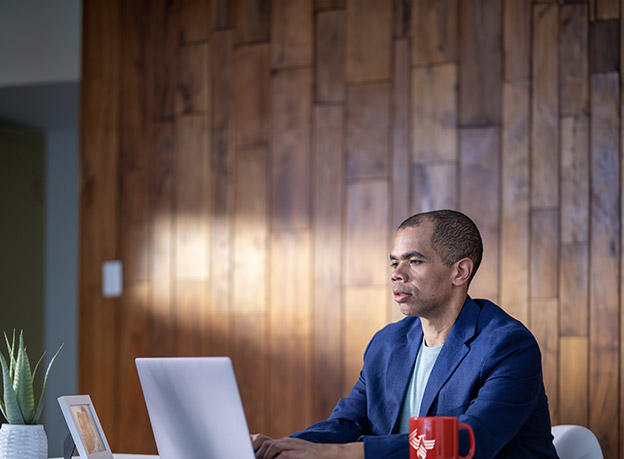 a business professional works at a laptop in a spacious office