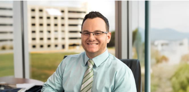 Business student smiling and sitting in an office