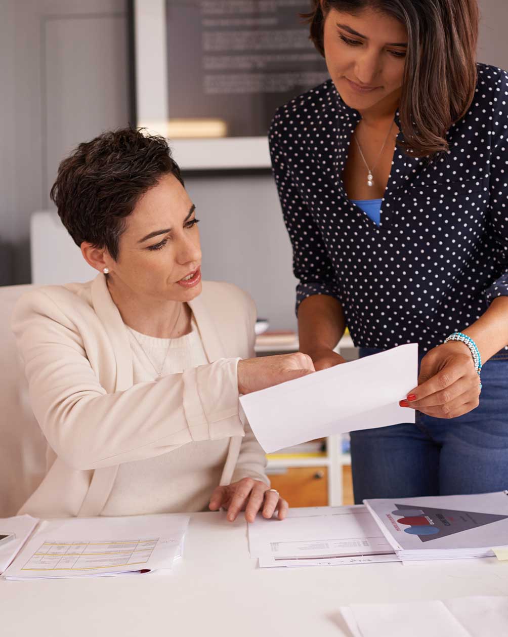 Coworkers looking over a document at work