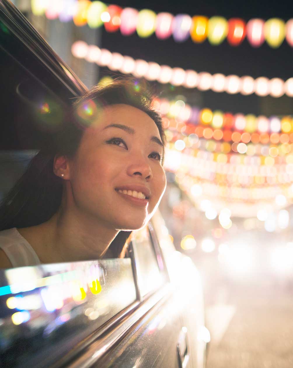 Woman looking out of the car window with a smile