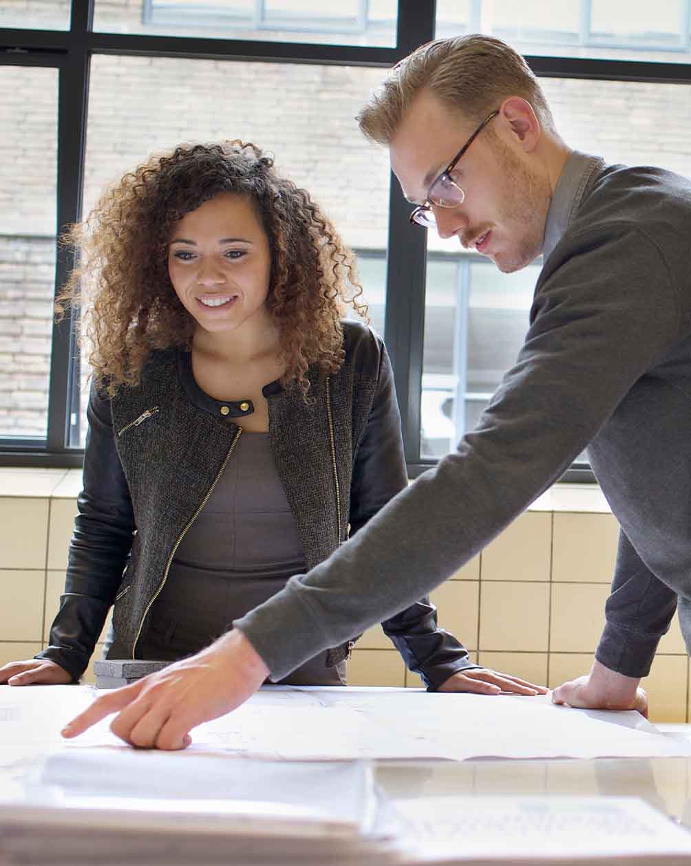 Woman and man going over documents in office