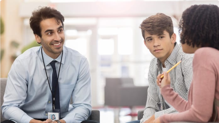 Three students sit together to discuss a psychology assignment.
