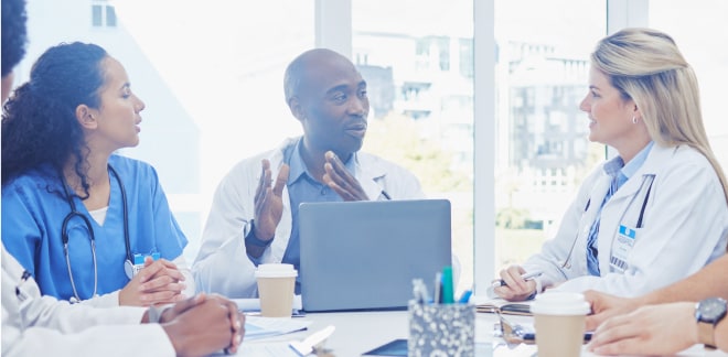 Business man presenting to healthcare workers in an office setting