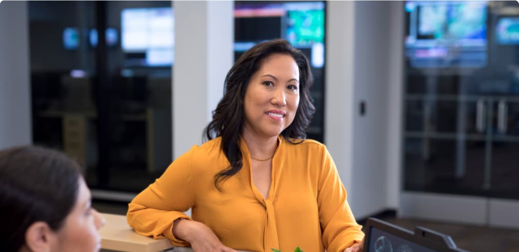 Woman smiling and standing in a work setting