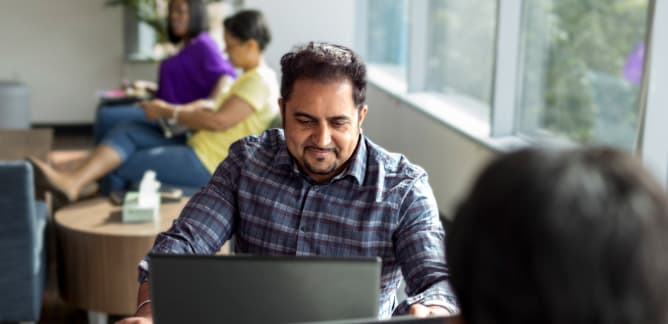 Software developers working amongst each other in an office