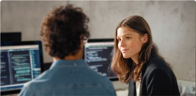 Software developers collaborating in an office with computers