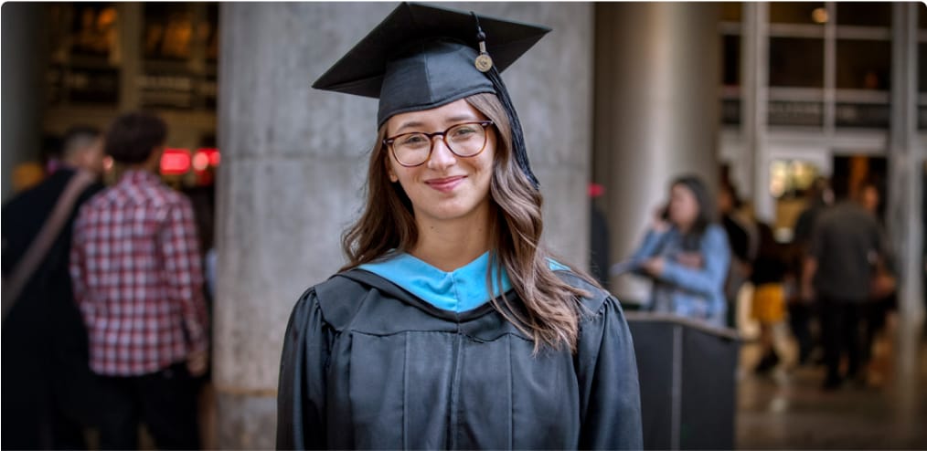 A graduate in cap and gown, signifying the Career Services for Life® commitment from her first class to graduation and beyond.