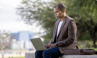 Business man at working on a laptop in a park