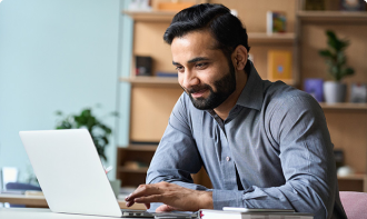 Business man working on a laptop at home in an office