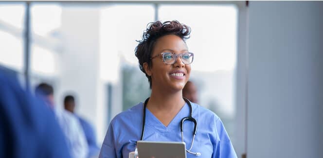 A woman works as a registered nurse after earning her BSN.