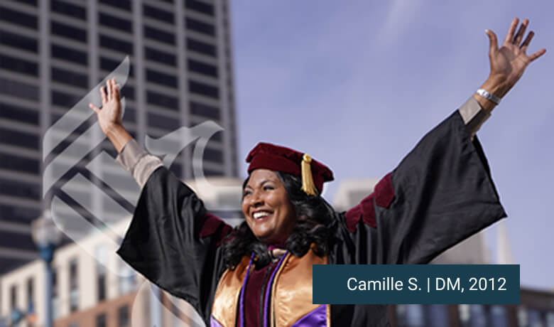 Camille, 2012 graduate, celebrating in cap and gown