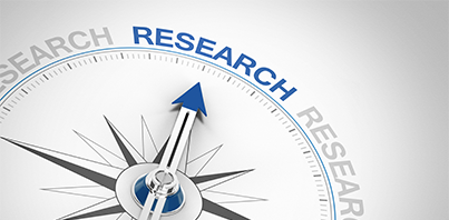 Illustration of a compass with the needle pointing to the word Research