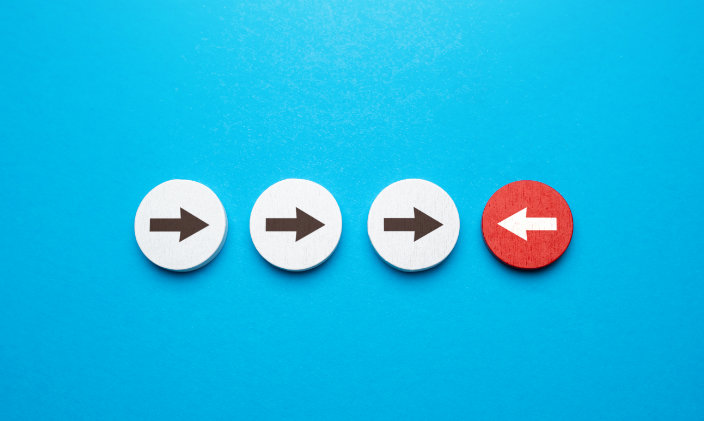Depiction of three arrows in blue pointing right and a red arrow pointing left